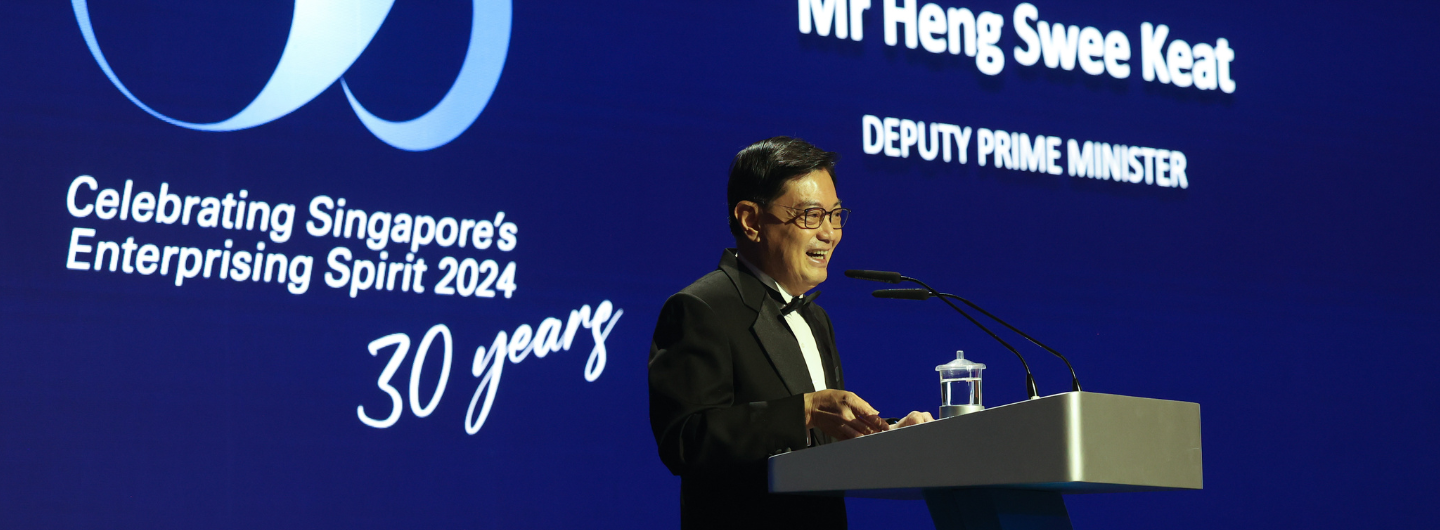 DPM Heng Swee Keat, at a podium against a "Celebrating Singapore's Enterprising Spirit 2024" backdrop.